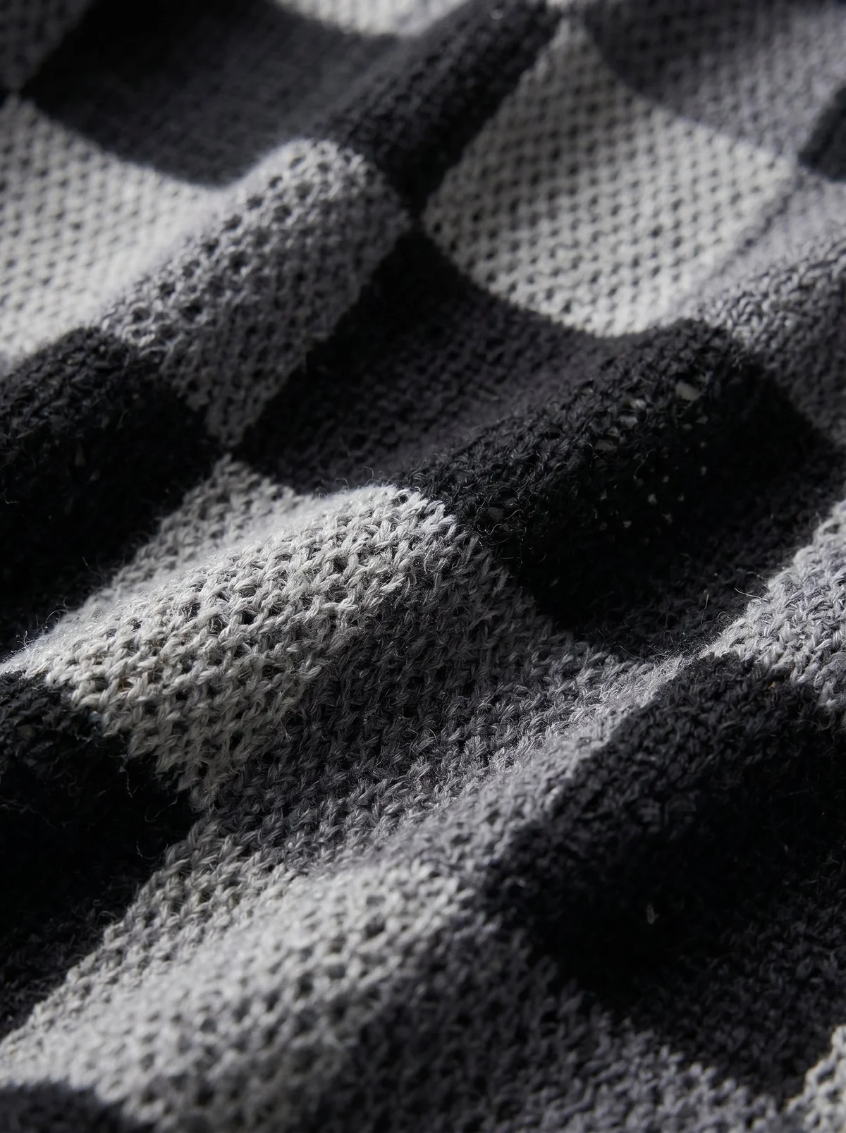 Close-up of the COLVIRE checkered knit fabric